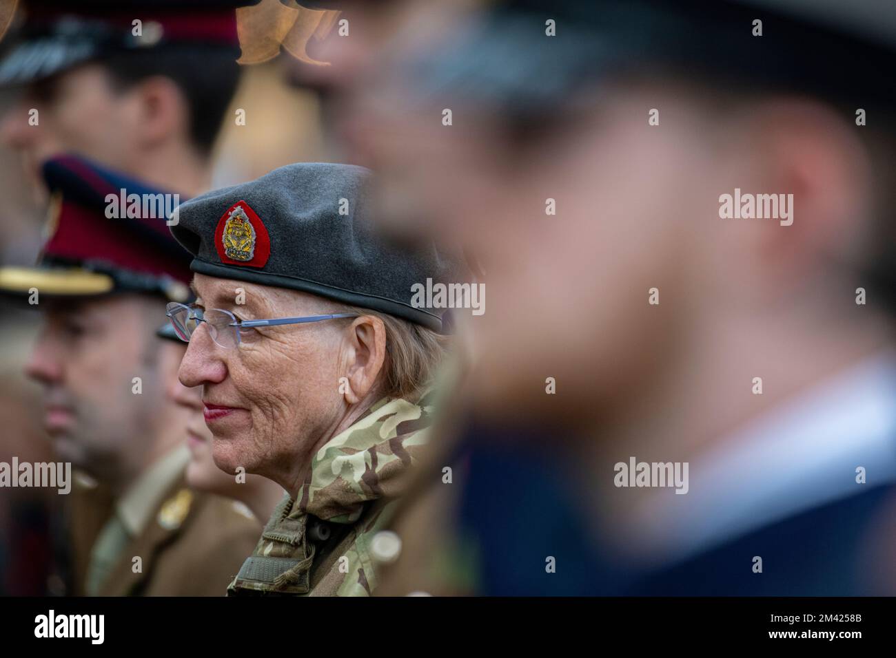 A woman represents the armed forces at a service of remembrance in Chelsea Stock Photo