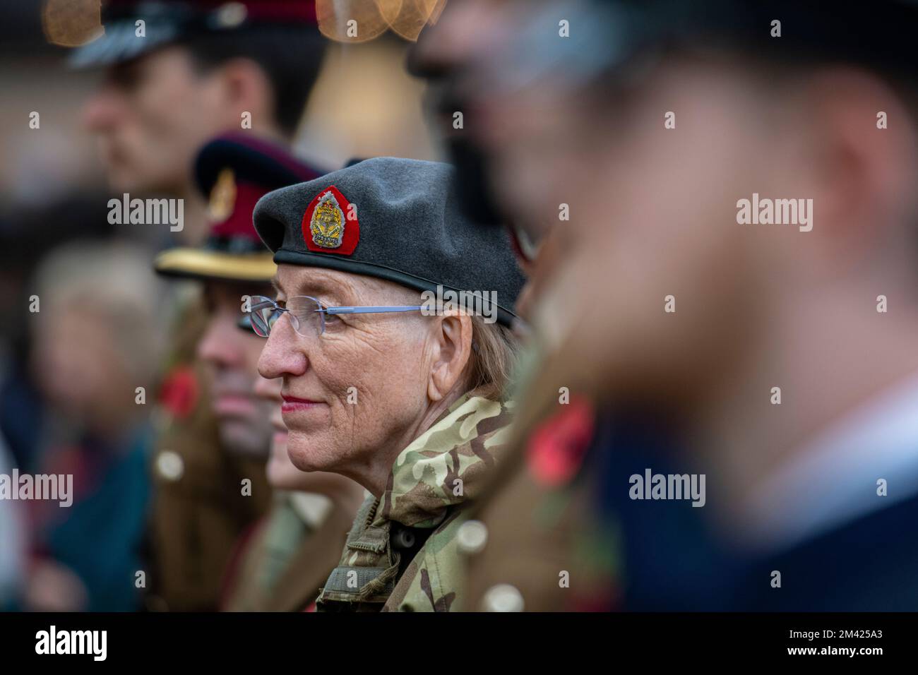 A woman represents the armed forces at a service of remembrance in Chelsea Stock Photo