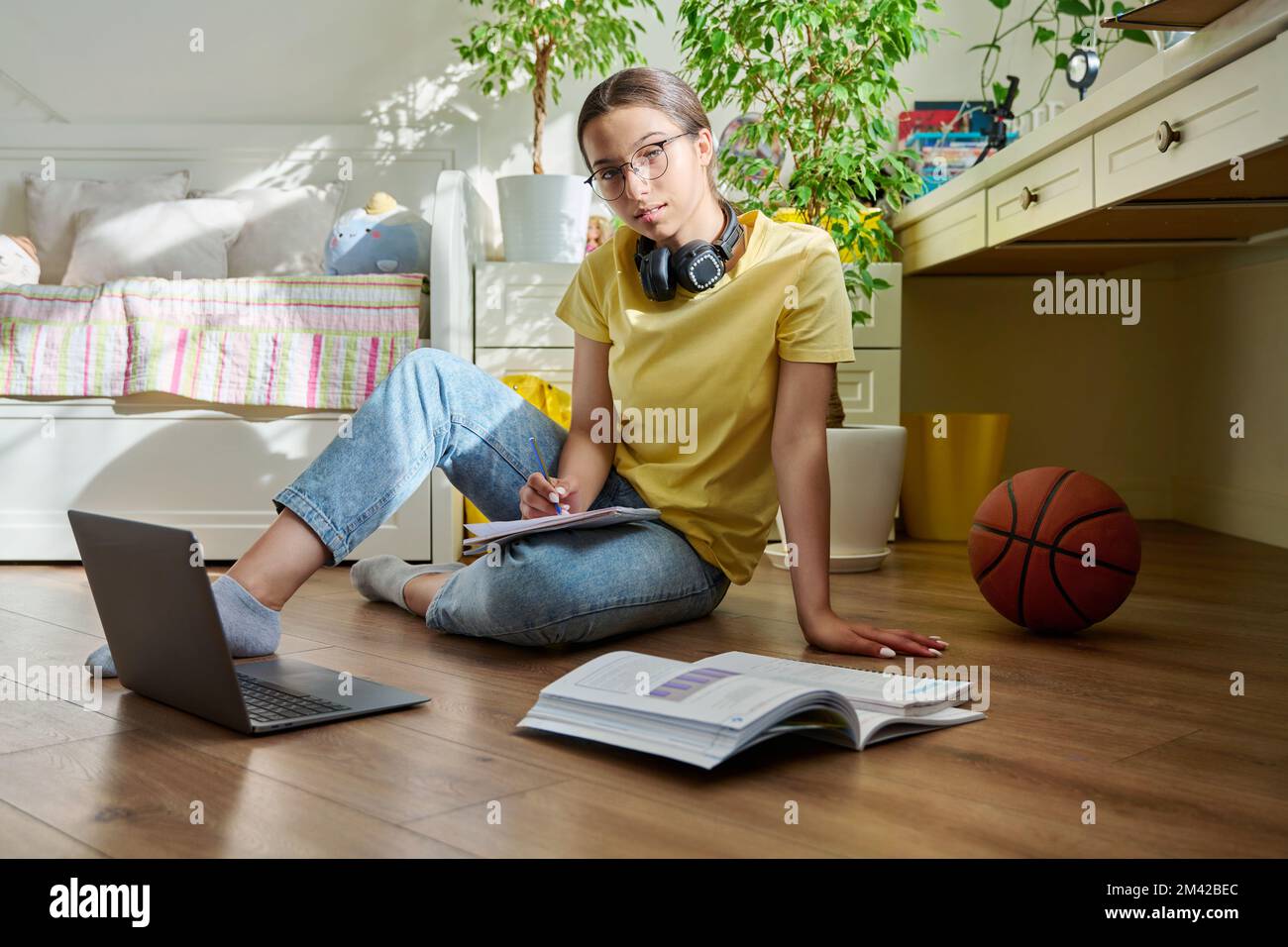 Teenage girl with glasses studying at home using a laptop Stock Photo ...