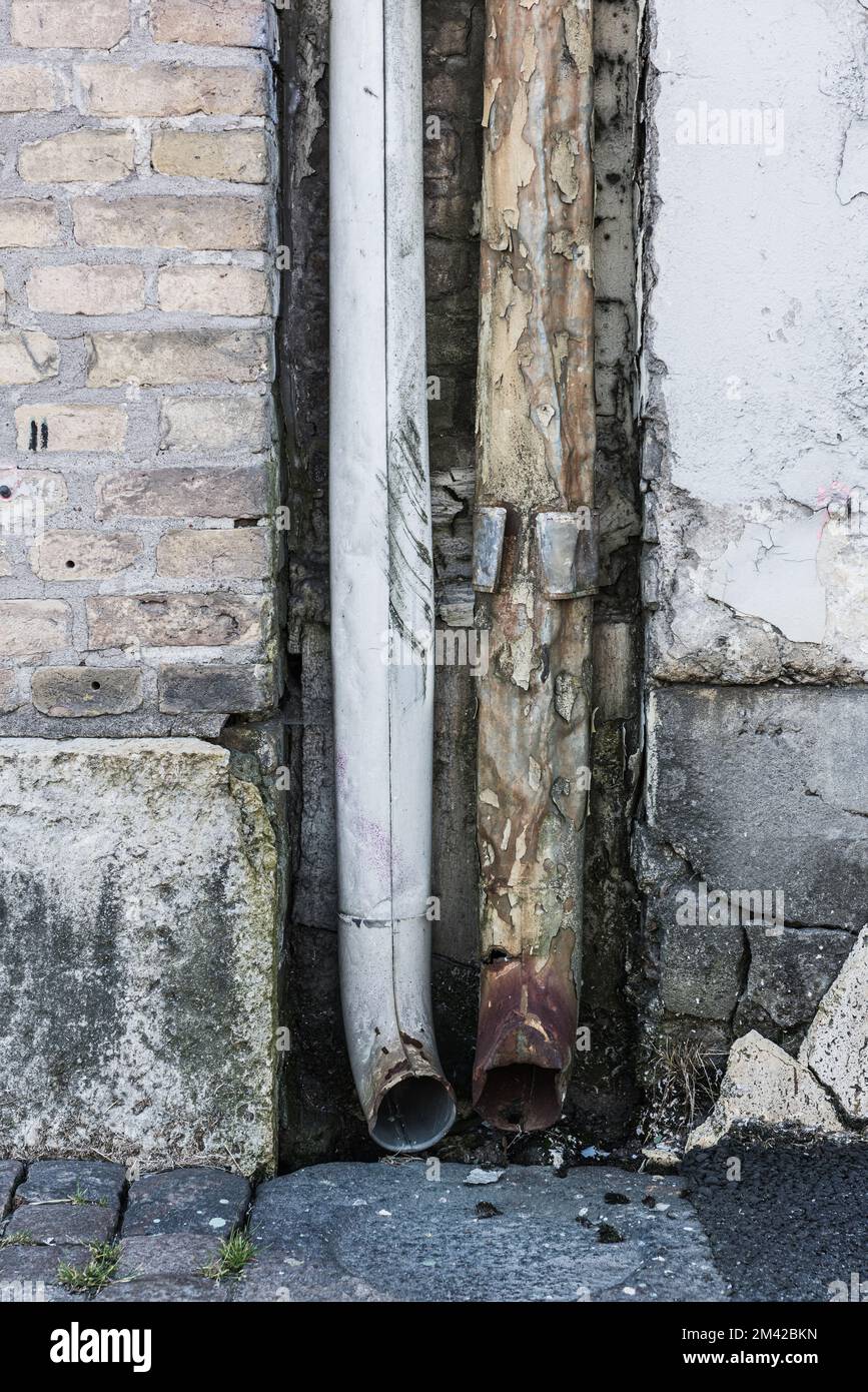 Worn out downpipes on facade Stock Photo