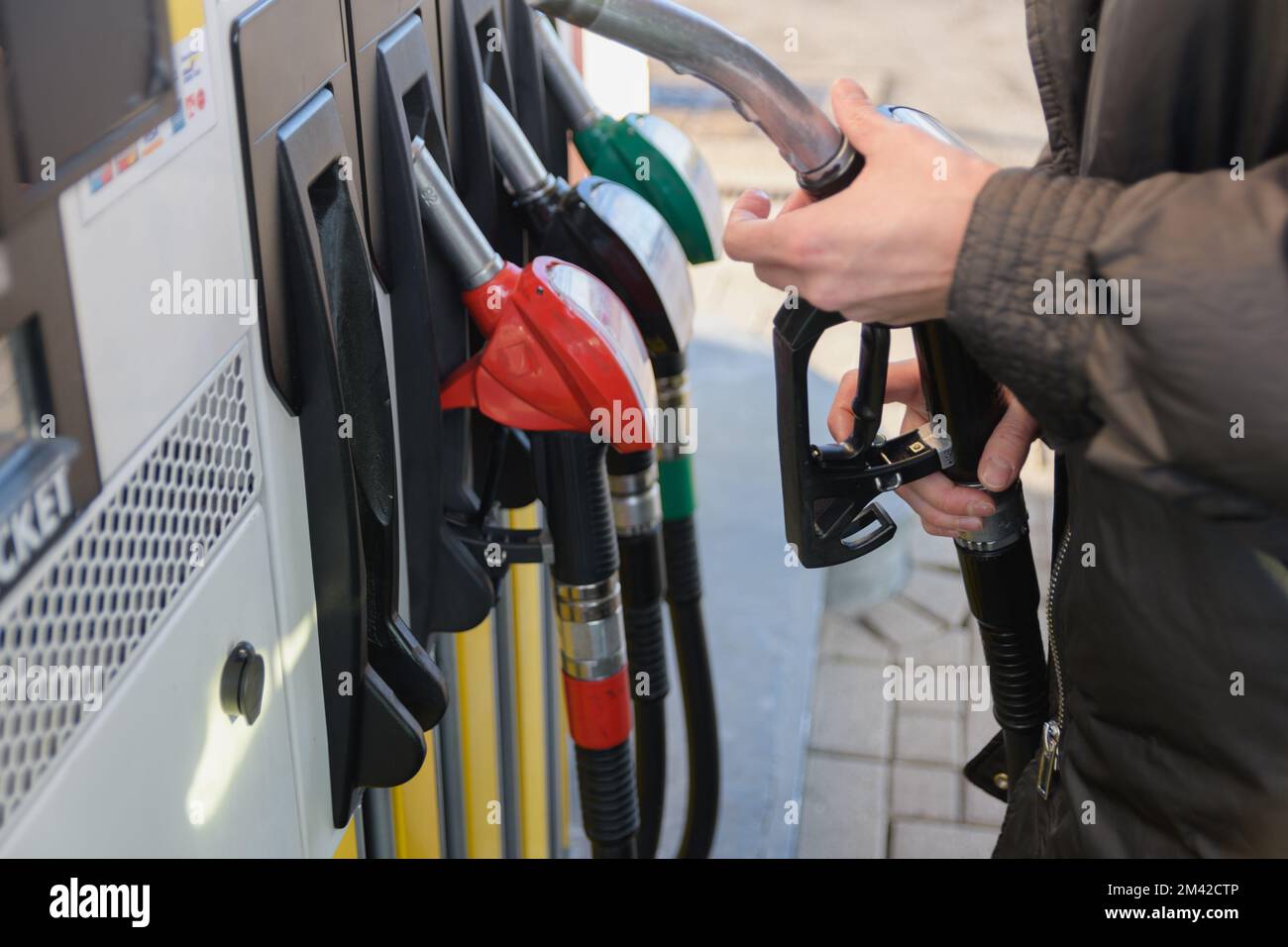 Using filling nozzles at a gas station. the woman takes out a filling pistol. selective focus Stock Photo