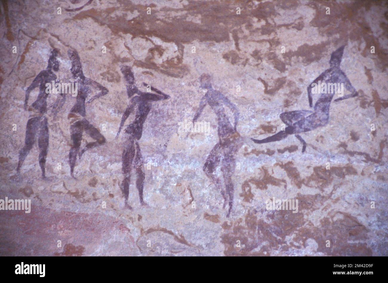 Exquisite Neolithic rock painting of females apparently dancing, Tassili N'Ajjer, South Algeria, Sahara desert. Stock Photo