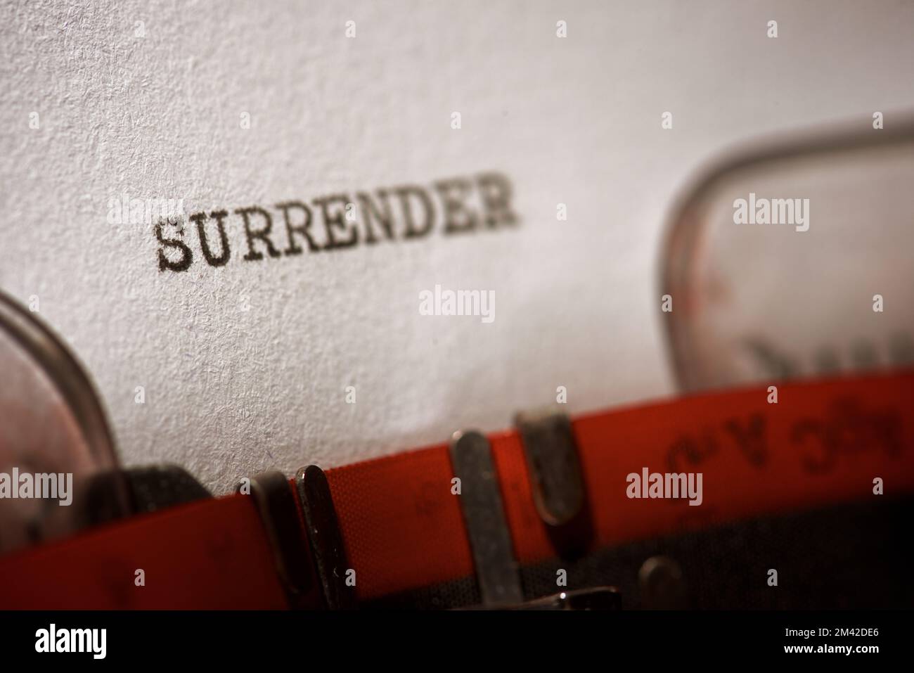 Surrender word written with a typewriter. Stock Photo