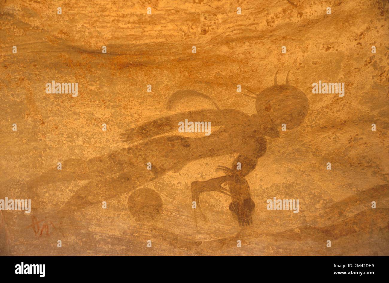 Neolithic rock painting of a human figure apparently swimming or floating, Tassili N'Ajjer, South Algeria, Sahara desert. Stock Photo