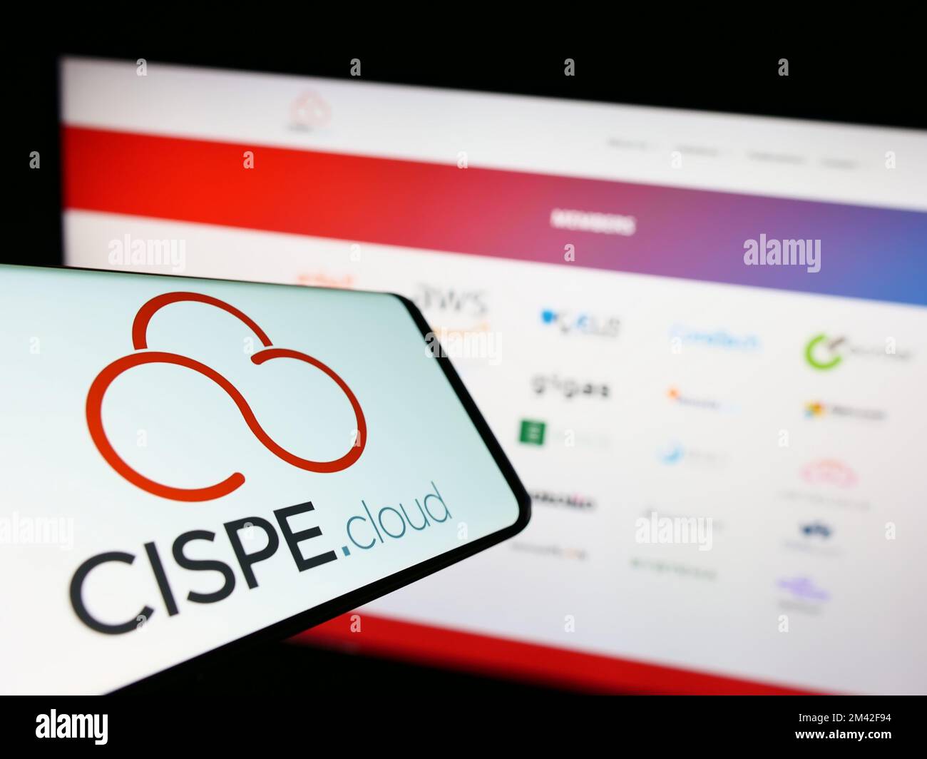 Cellphone with logo of cloud providers trade association CISPE on screen in front of business website. Focus on right of phone display. Stock Photo