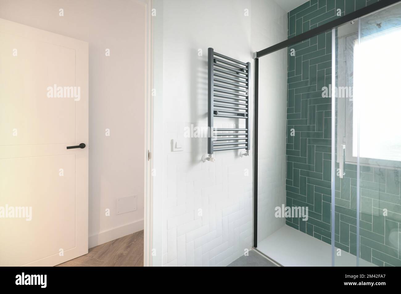 Contemporary designed cloakroom with black aluminum heated towel rail