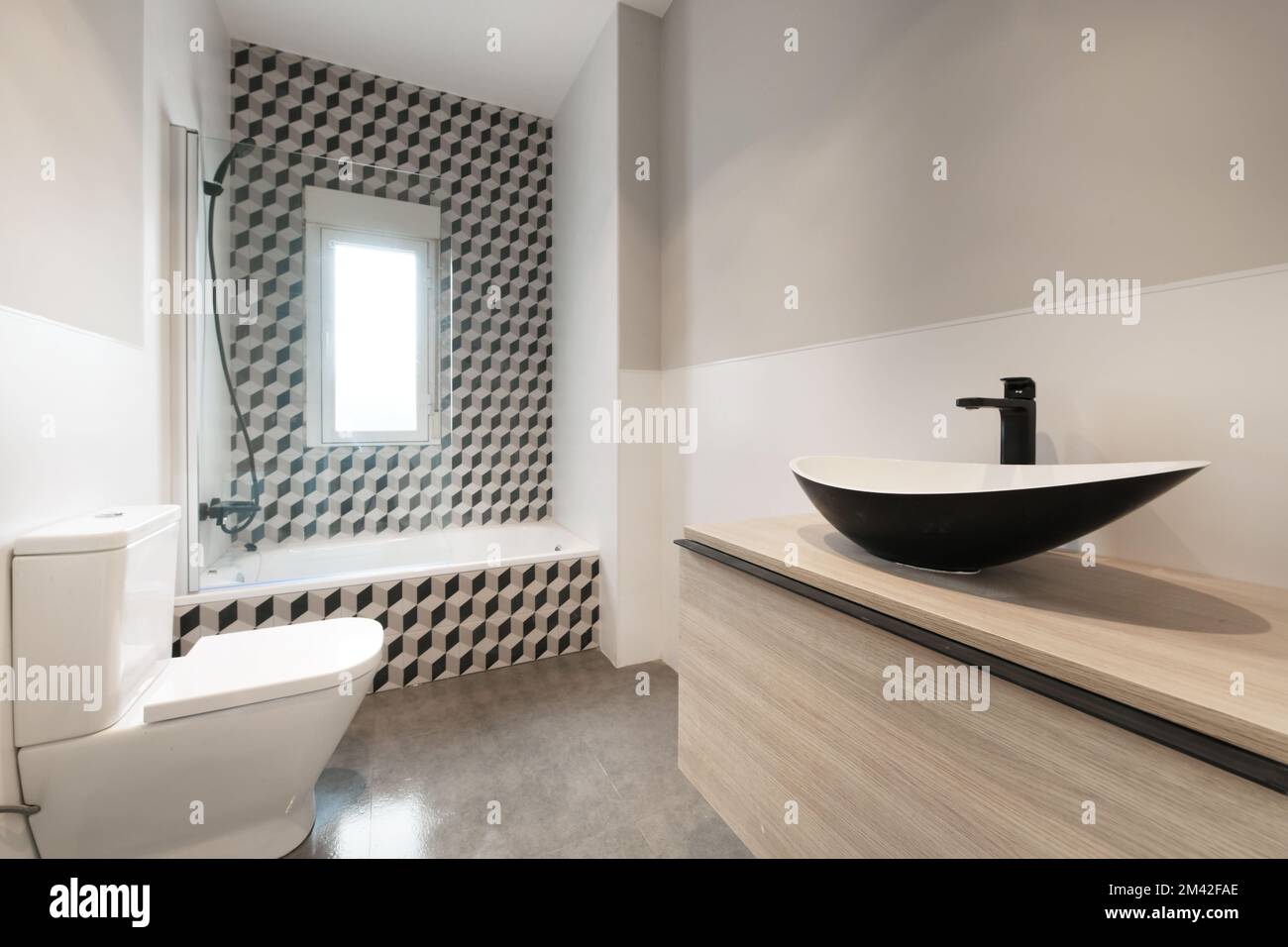 Contemporary designer bathroom with teardrop shaped black porcelain toilets with shower column