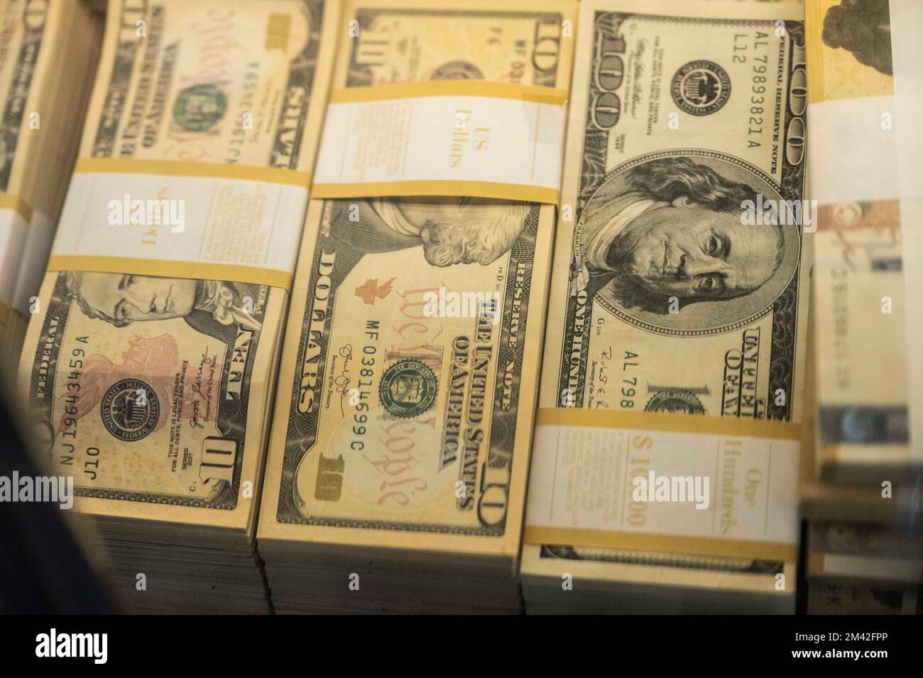 Tokyo, Japan. 16th Dec, 2022. Stacks of US Dollar bills featuring 10