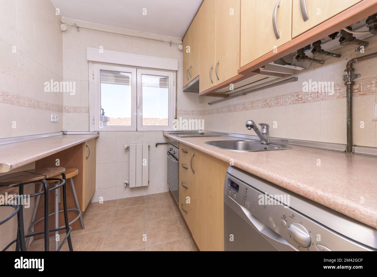 Conventional Wood Kitchen with Builtin Appliances and Window