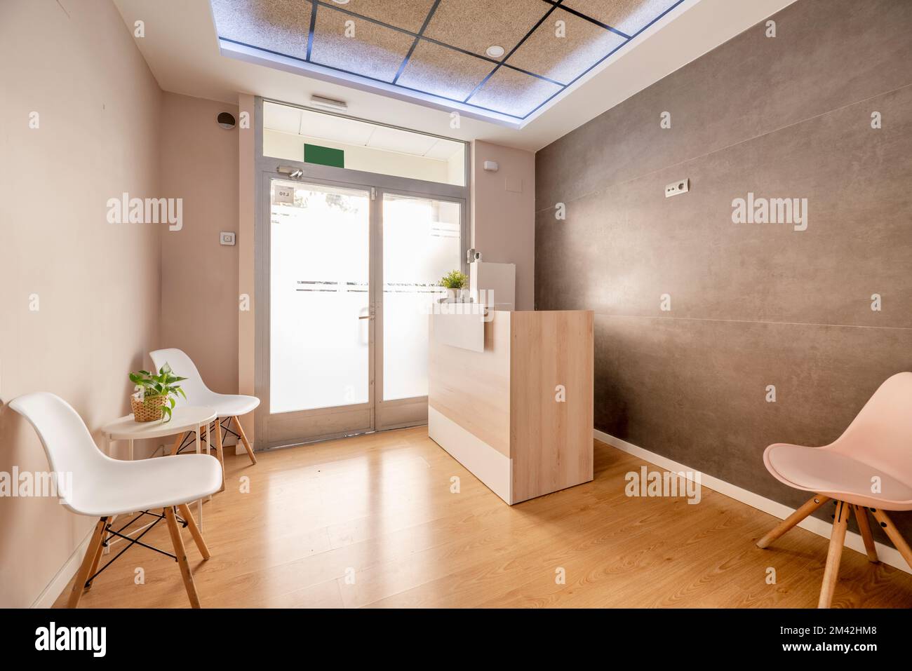 Reception desk and waiting room of a beauty salon with white resin