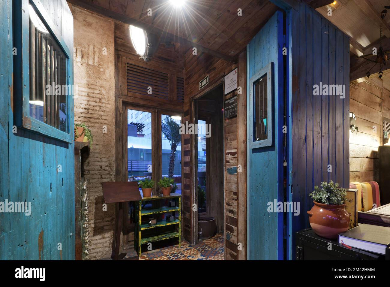 Hall of a restaurant with blue wooden doors hydraulic ceramic floors