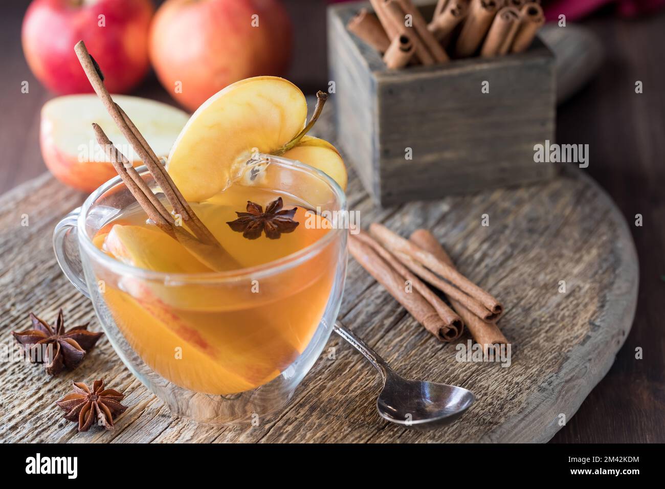 A look into a glass tea cup of homemade mulled apple cider with garnishments. Stock Photo