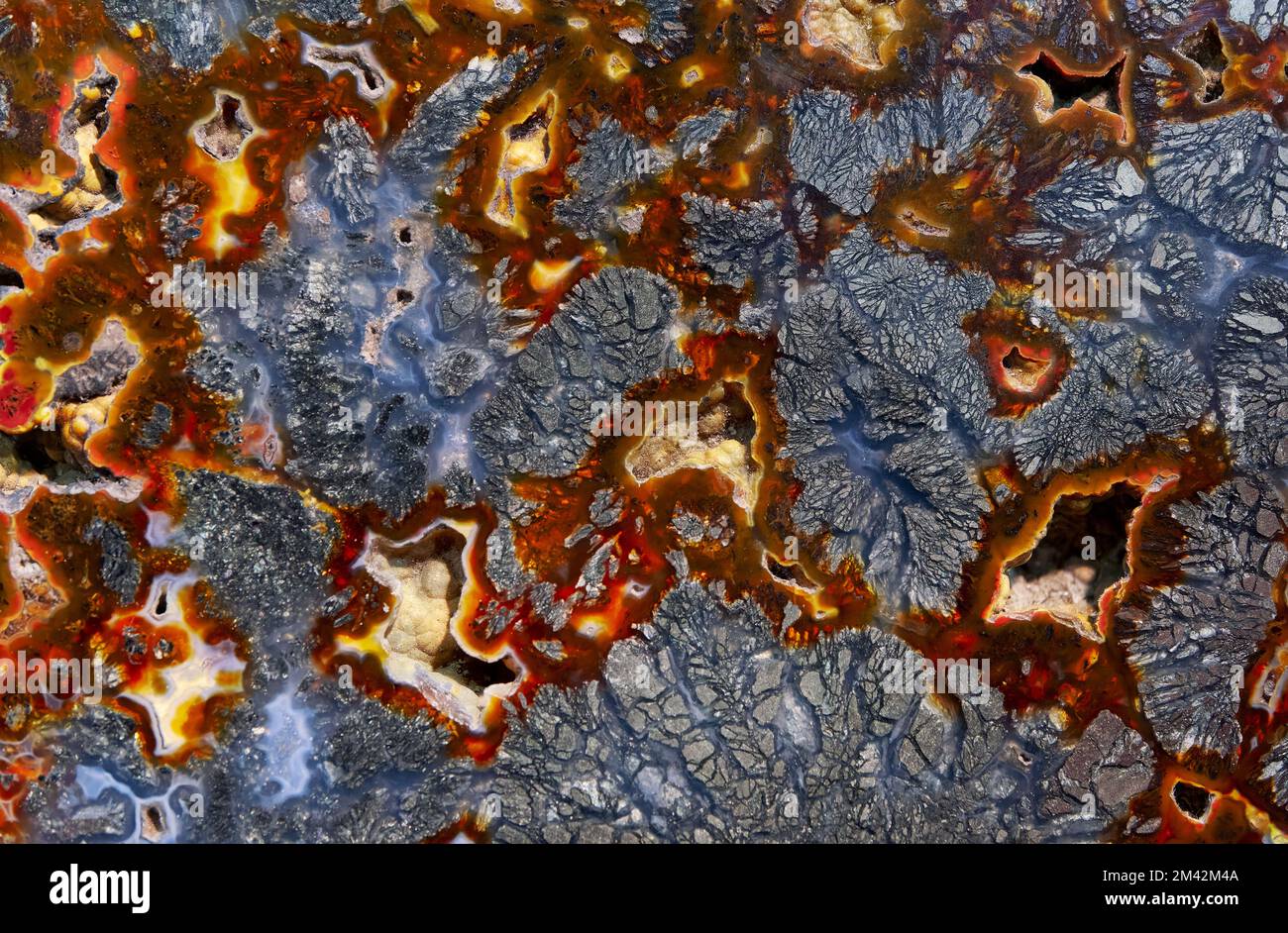 Backgrounds and textures: surface of beautiful decorative stone, abstract colorful red and blue mineral pattern with cracks, spots and stains, natural Stock Photo