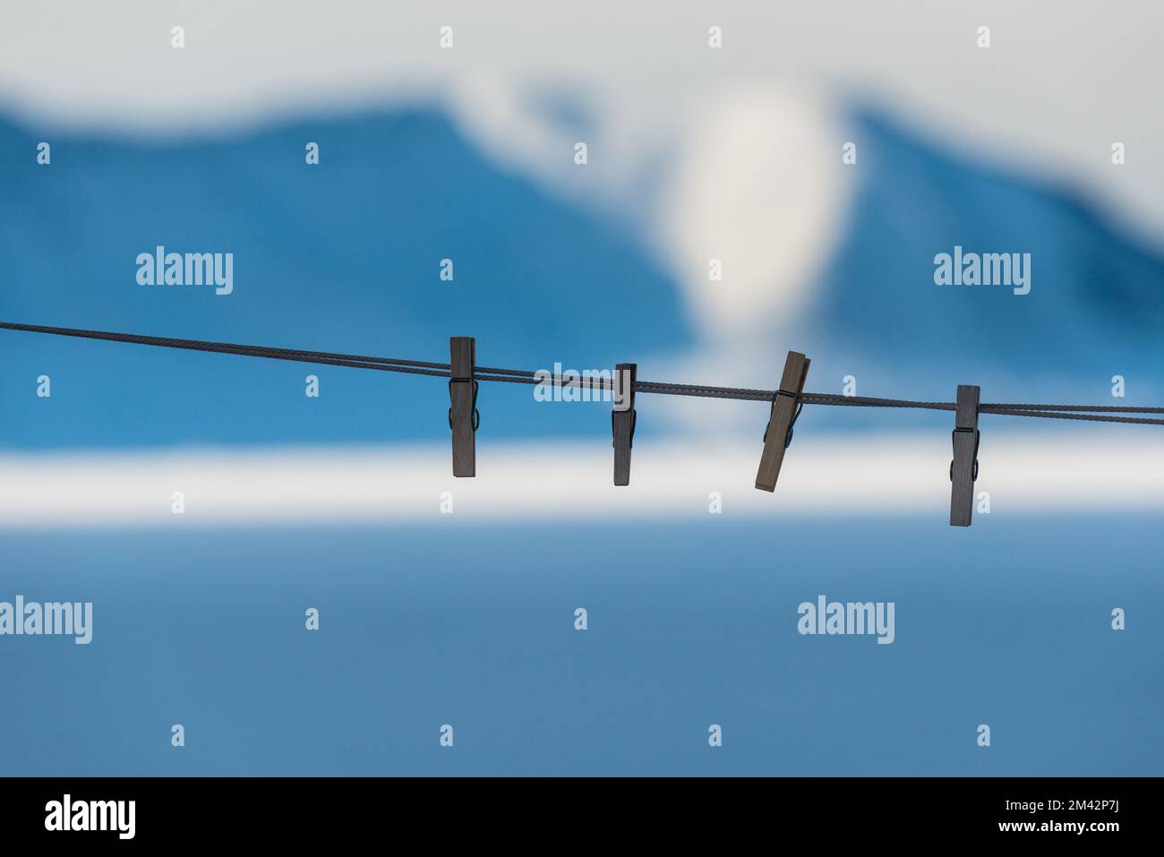 Pegs on washing line in front of mountain scenery, Greenland Stock