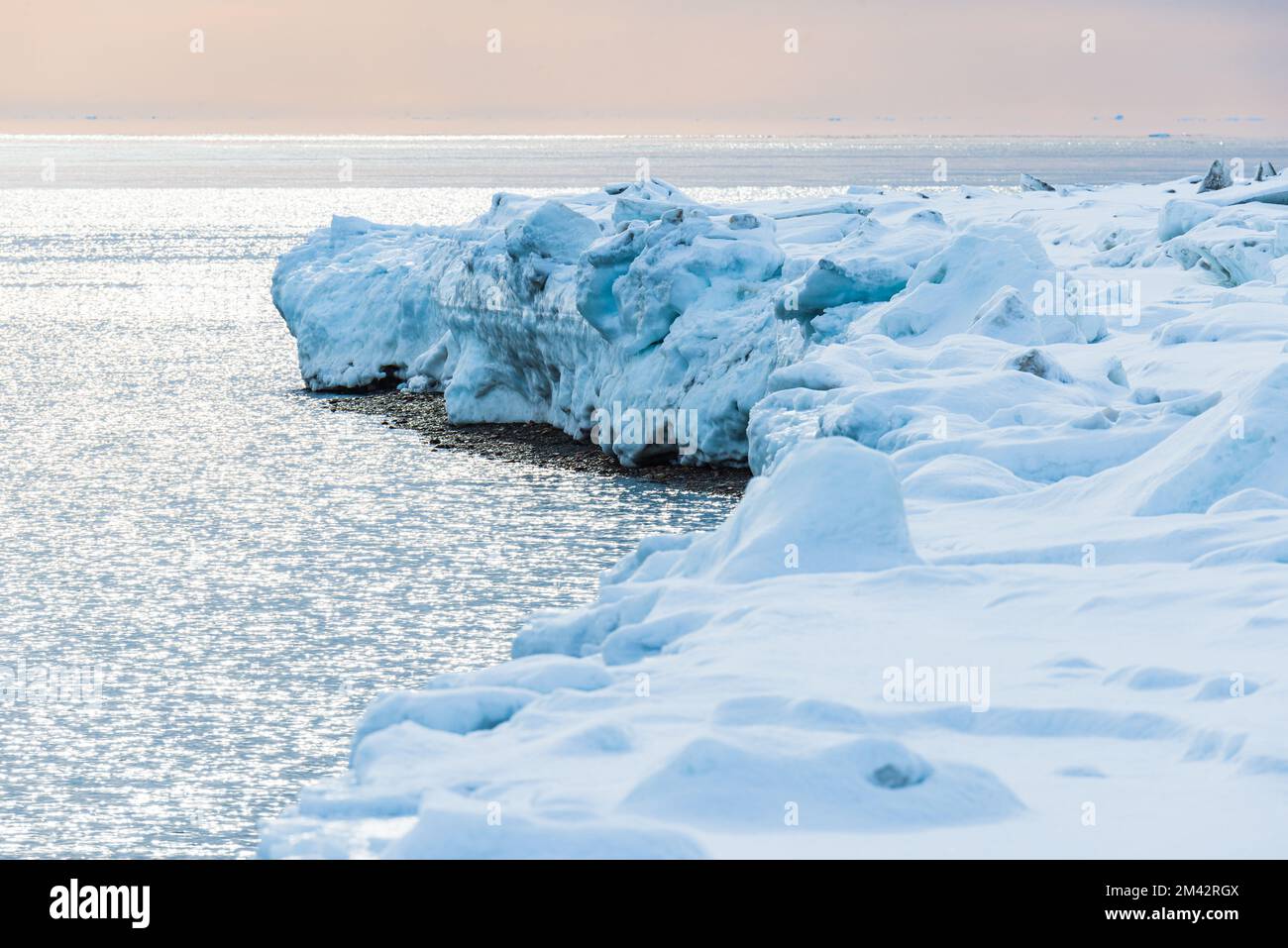 Icy coastline with open water at Greenland Stock Photo