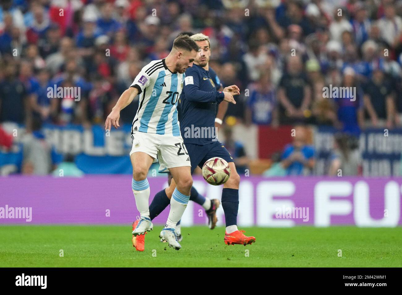 LUSAIL, QATAR - DECEMBER 18: Player of Argentina Alexis Mac Allister fights for the ball with player of France Antoine Griezmann during the FIFA World Cup Qatar 2022 Final match between Argentina and France at Lusail Stadium on December 18, 2022 in Lusail, Qatar. (Photo by Florencia Tan Jun/PxImages) Credit: Px Images/Alamy Live News Stock Photo
