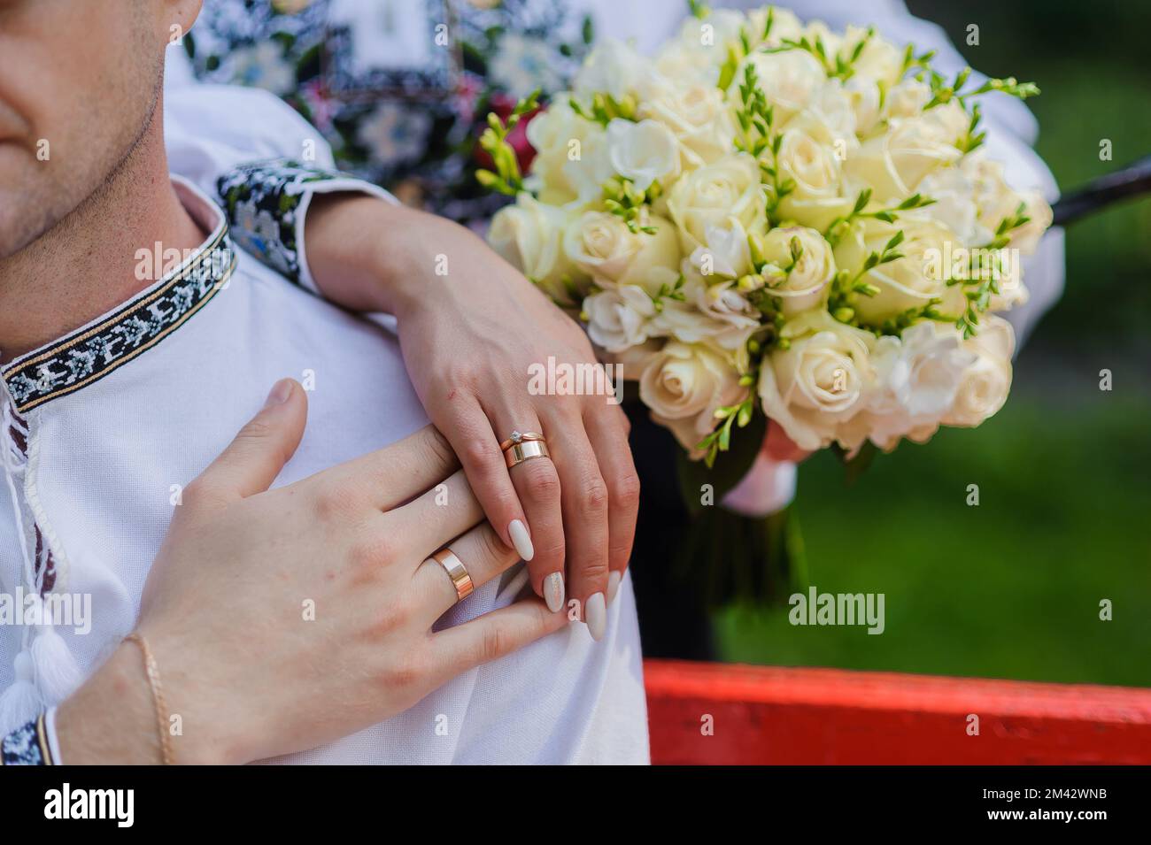 Golden wedding rings on the hands of the newlyweds. Man and woman in