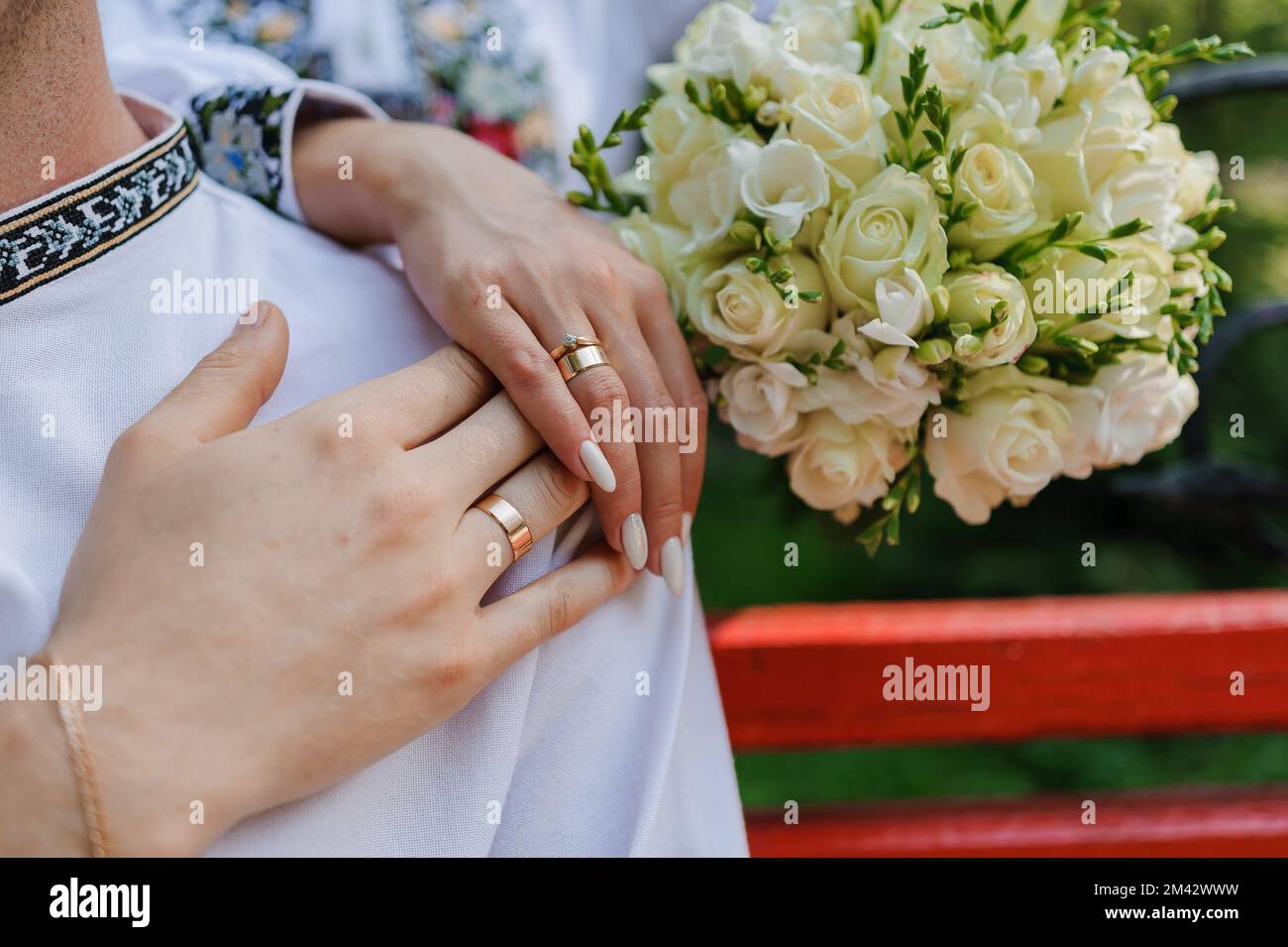 Golden wedding rings on the hands of the newlyweds. Man and woman in