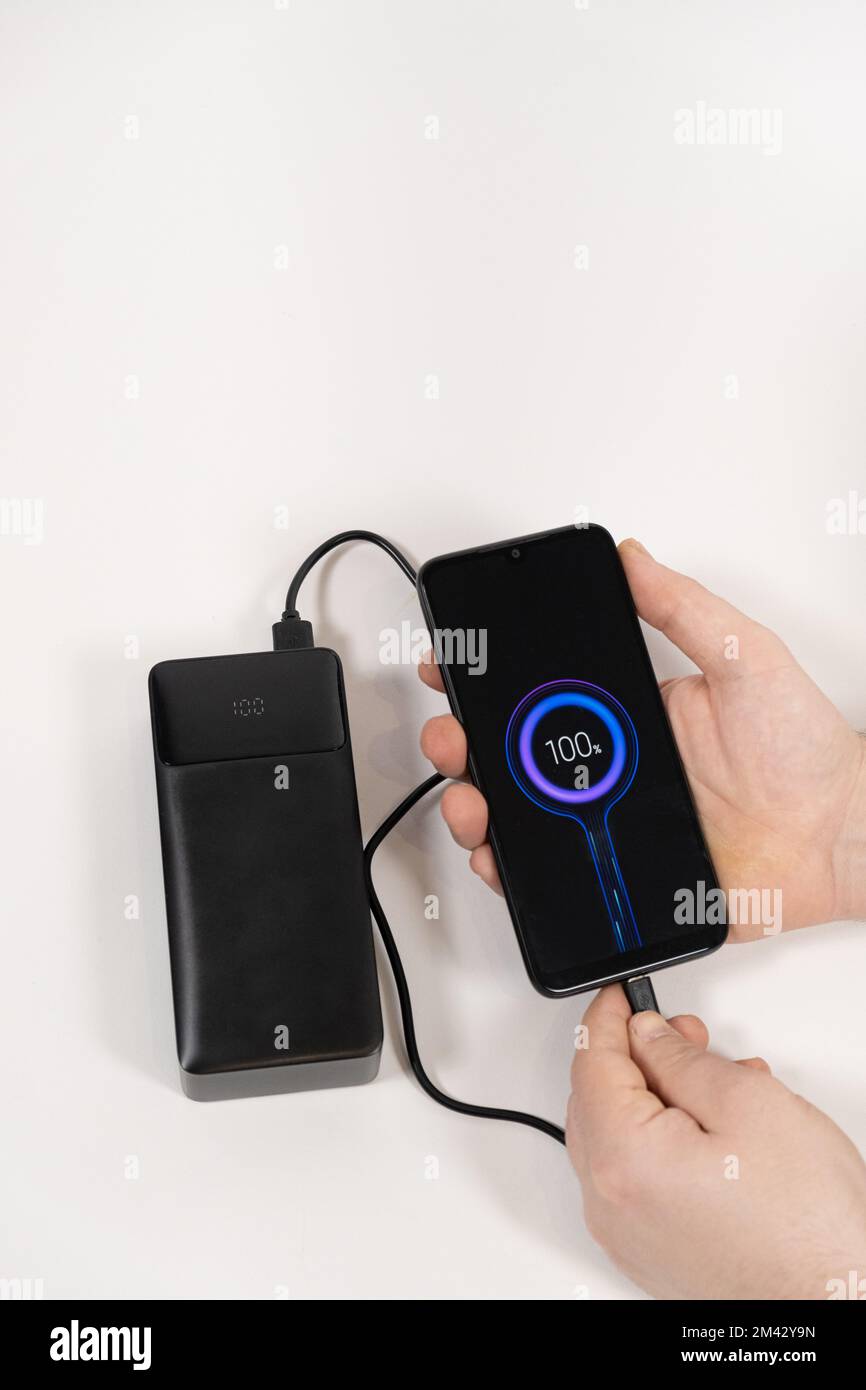 Connecting a mobile phone to a power bank. Charging gadgets from power