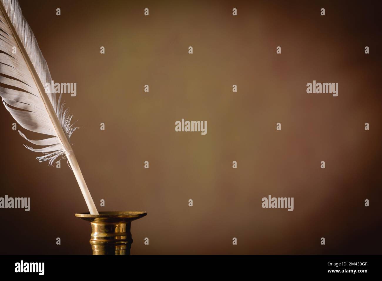 Inkwell and quill pen on a dark background. Vintage concept