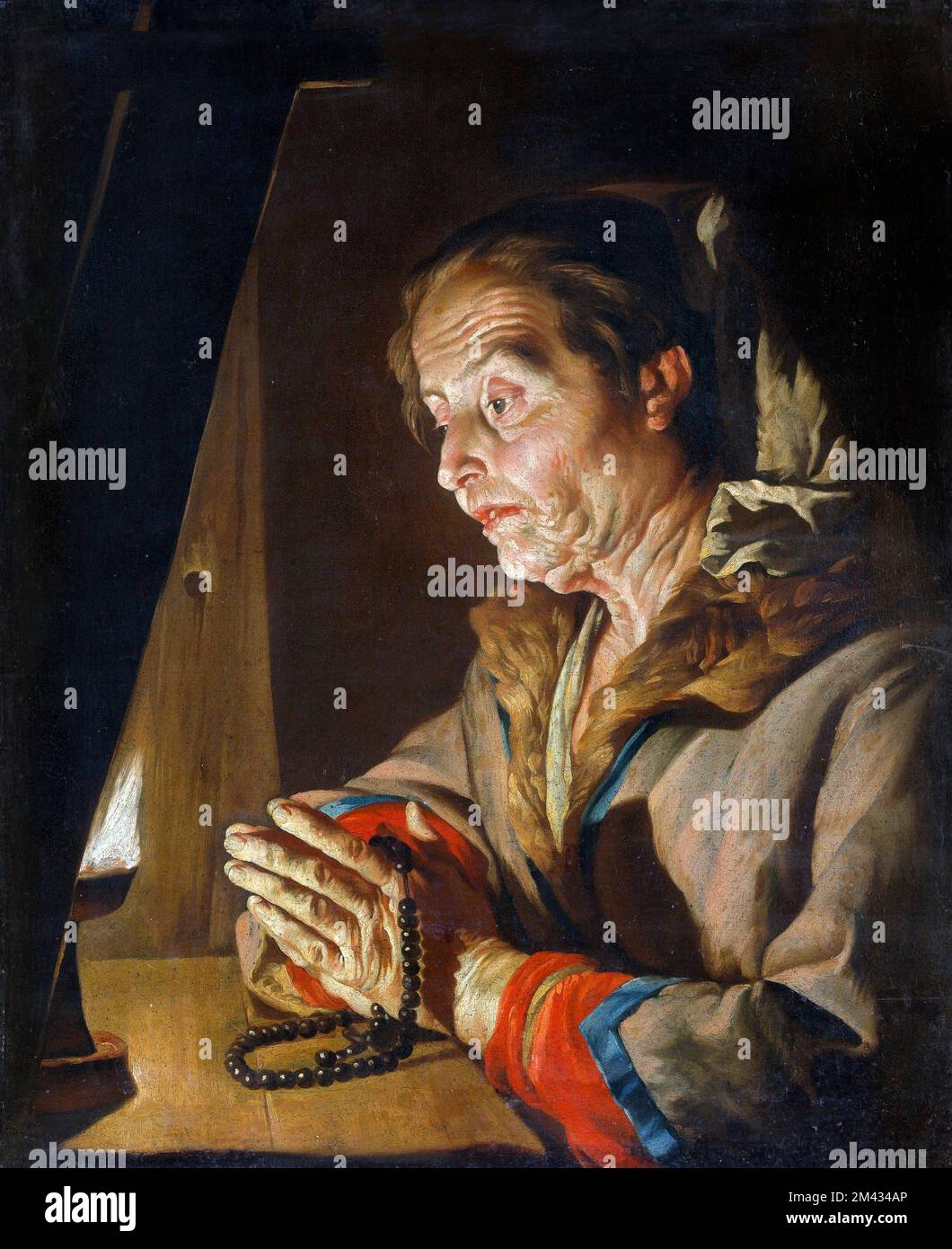 Old Woman Praying by Matthias Stom (c. 1600-c. 1652), oil on canvas, late 1630s- early 1640s Stock Photo