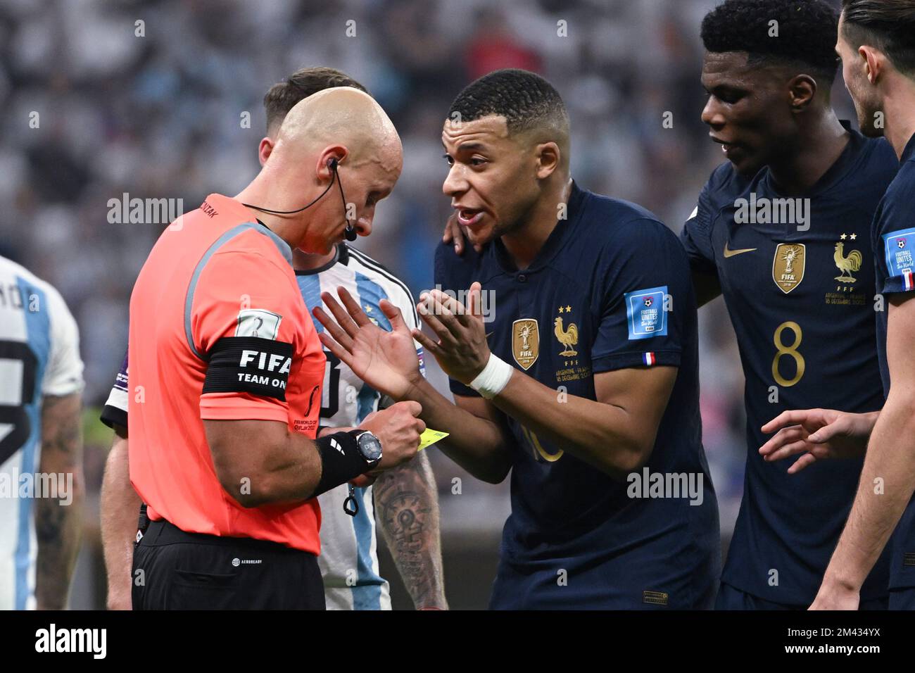Lusaier, Qatar. 18th Dec, 2022. Kylian Mbappe (3rd R) of France talks to Referee Szymon Marciniak during the Final between Argentina and France at the 2022 FIFA World Cup at Lusail Stadium in Lusail, Qatar, Dec. 18, 2022. Credit: Li Ga/Xinhua/Alamy Live News/Alamy Live News Stock Photo