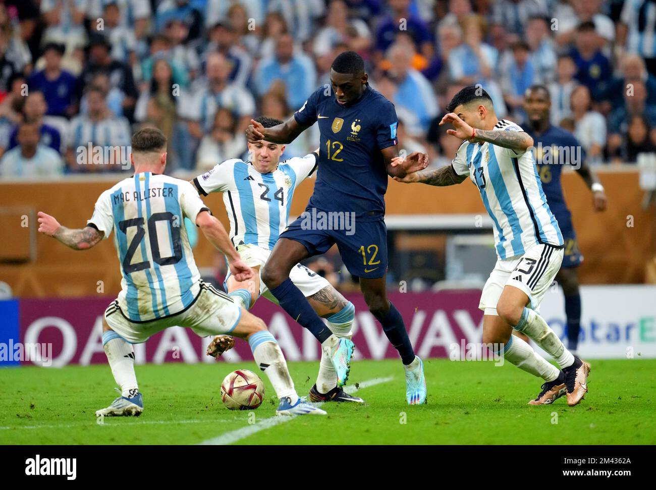 France's Randal Kolo Muani (centre) battles for the ball against