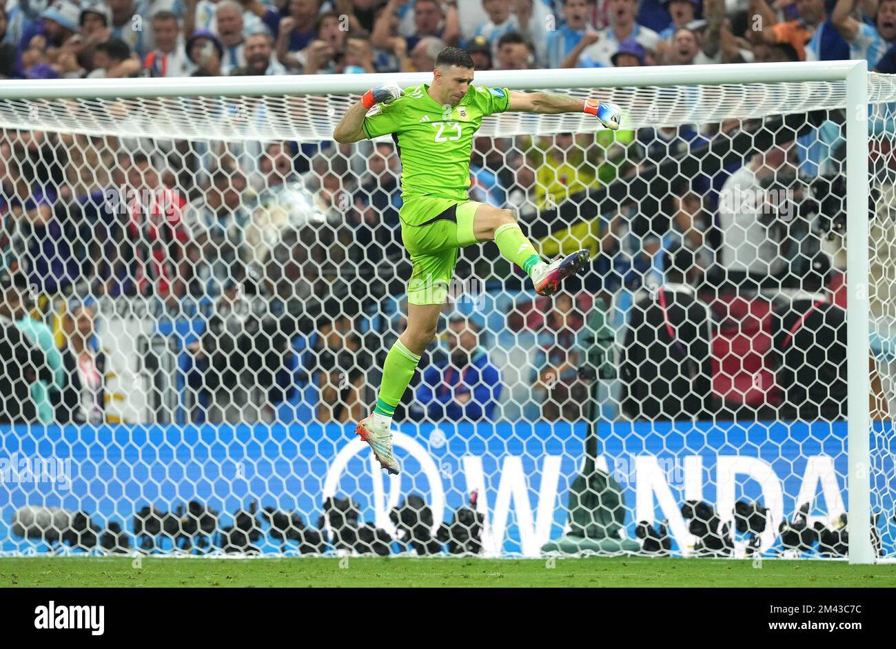 Argentina goalkeeper Emiliano Martinez celebrates after saving France's Kingsley Coman's penalty in the penalty shoot-out after extra time during the FIFA World Cup final at Lusail Stadium, Qatar. Picture date: Sunday December 18, 2022. Stock Photo