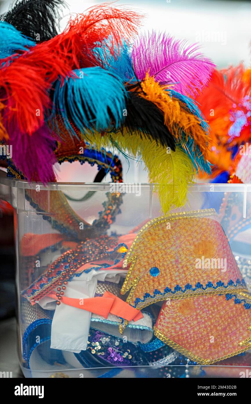 Plastic tub containing costumes for a Caribbean Festival Parade Stock Photo