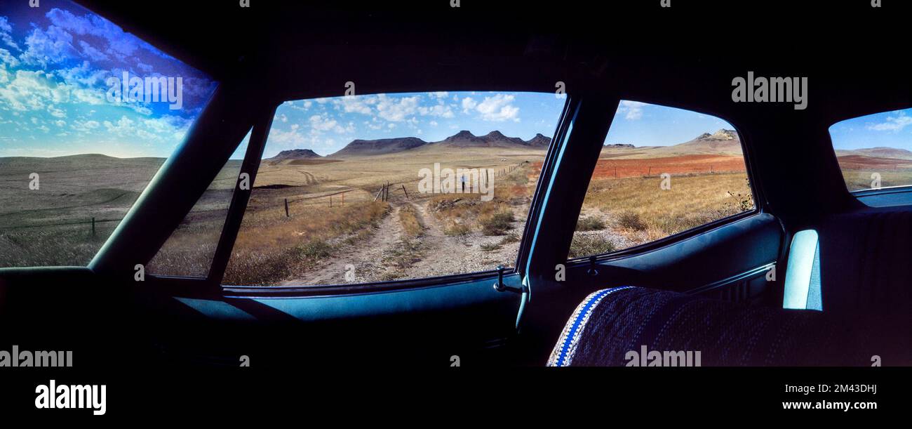 Panorama landscape through the windows of a vintage touring car of Dogtooth Buttes in Grant Count near Raleigh, North Dakota, USA Stock Photo