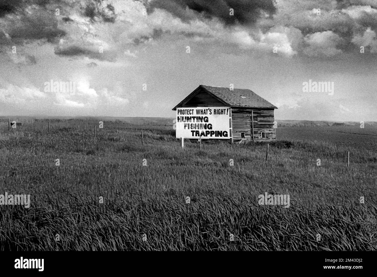 Landscape with stormy weather and a granary with a political sign advocating for hunters rights stating, “Protect What's Right, Hunting, Fishing, Tra Stock Photo