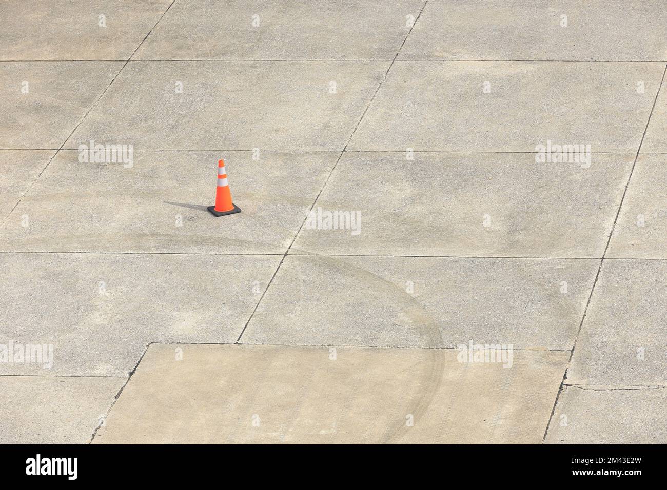 Traffic Cone On Empty Airport Runway Striped White Orange Traffic traffic-cone-on-empty-airport-runway-striped-white-orange-traffic