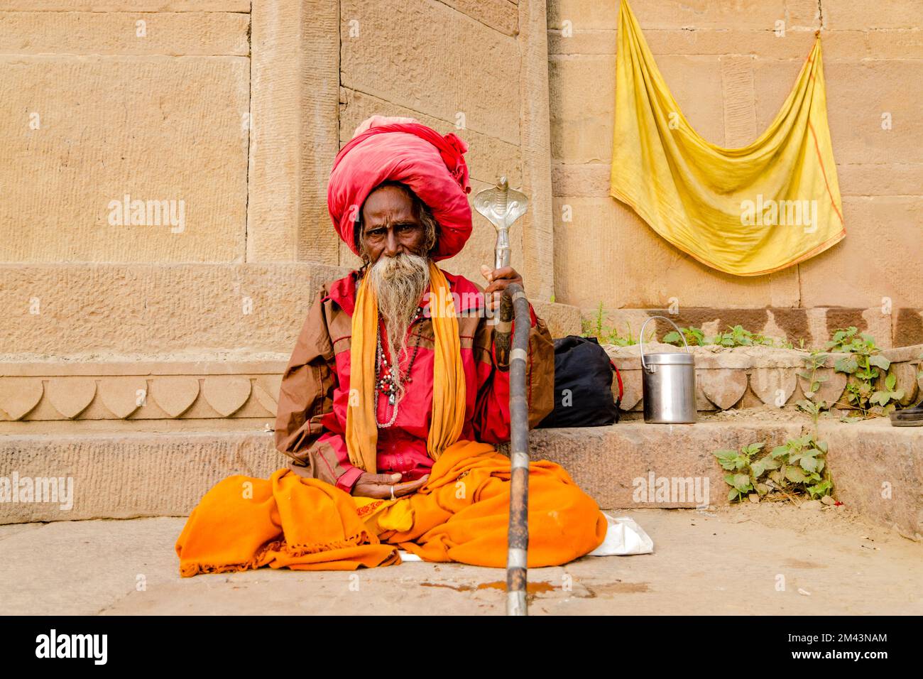 Sadhu, holy man, sitting at one of the ghats of the old city Stock Photo