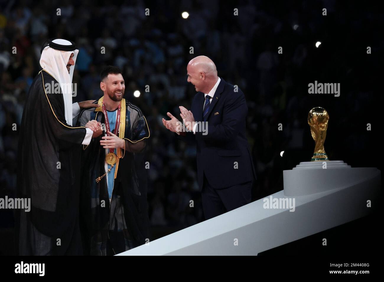 Lusail, Qatar. 18th Dec, 2022. FIFA President Gianni Infantino (R) and The Emir of Qatar Sheikh Tamim bin Hamad Al Thani (L) award Lionel Messi of Argentina during the awarding ceremony of the 2022 FIFA World Cup at Lusail Stadium in Lusail, Qatar, Dec. 18, 2022. Credit: Lan Hongguang/Xinhua/Alamy Live News/Alamy Live News Stock Photo