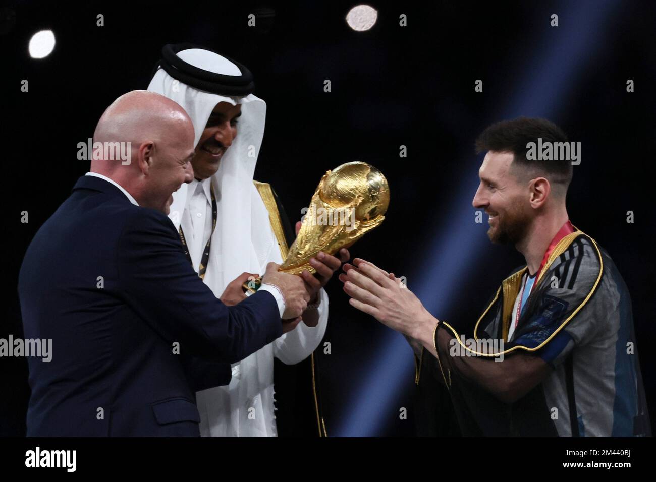 Lusail, Qatar. 18th Dec, 2022. FIFA President Gianni Infantino (L) and The Emir of Qatar Sheikh Tamim bin Hamad Al Thani (C) award Lionel Messi of Argentina during the awarding ceremony of the 2022 FIFA World Cup at Lusail Stadium in Lusail, Qatar, Dec. 18, 2022. Credit: Lan Hongguang/Xinhua/Alamy Live News/Alamy Live News Stock Photo