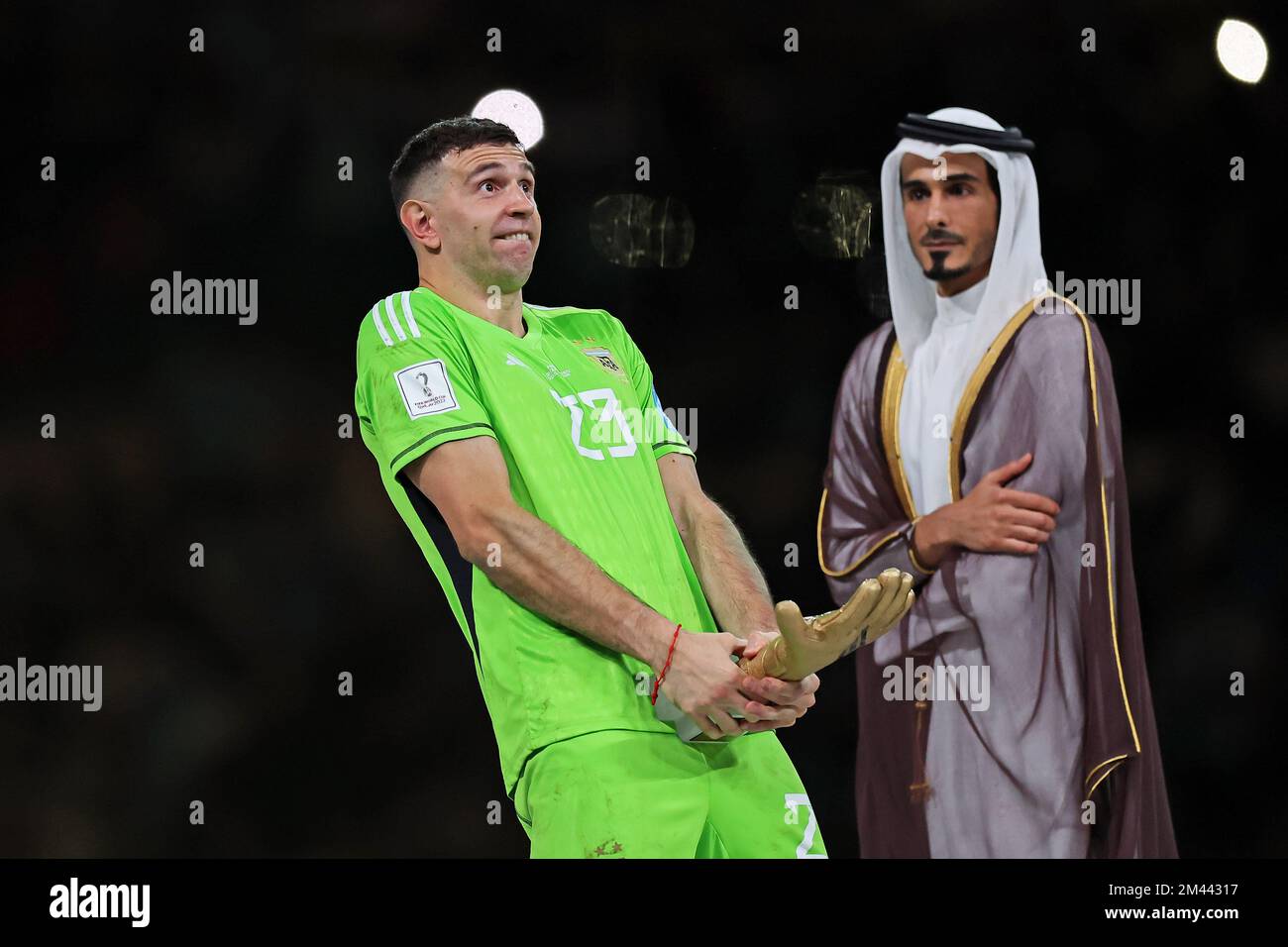 Lusail Iconic Stadium, Lusail, Qatar. 18th Dec, 2022. FIFA World Cup Football Final Argentina versus France; Emiliano Mart&#xed;nez of Argentina goofs around on the podium after winning the goalkeeper of the tournament trophy Credit: Action Plus Sports/Alamy Live News Stock Photo