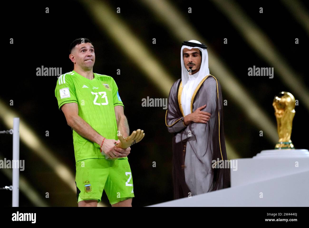 Argentina goalkeeper Emiliano Martinez celebrates with the Golden Glove award after being presented with it following victory in the FIFA World Cup final at Lusail Stadium, Qatar. Picture date: Sunday December 18, 2022. Stock Photo