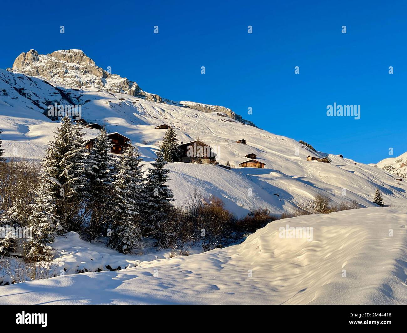 Wonderful winter landscape with traditional wooden mountain huts in Partnun. Praettigau, Graubuenden, Switzerland. Stock Photo