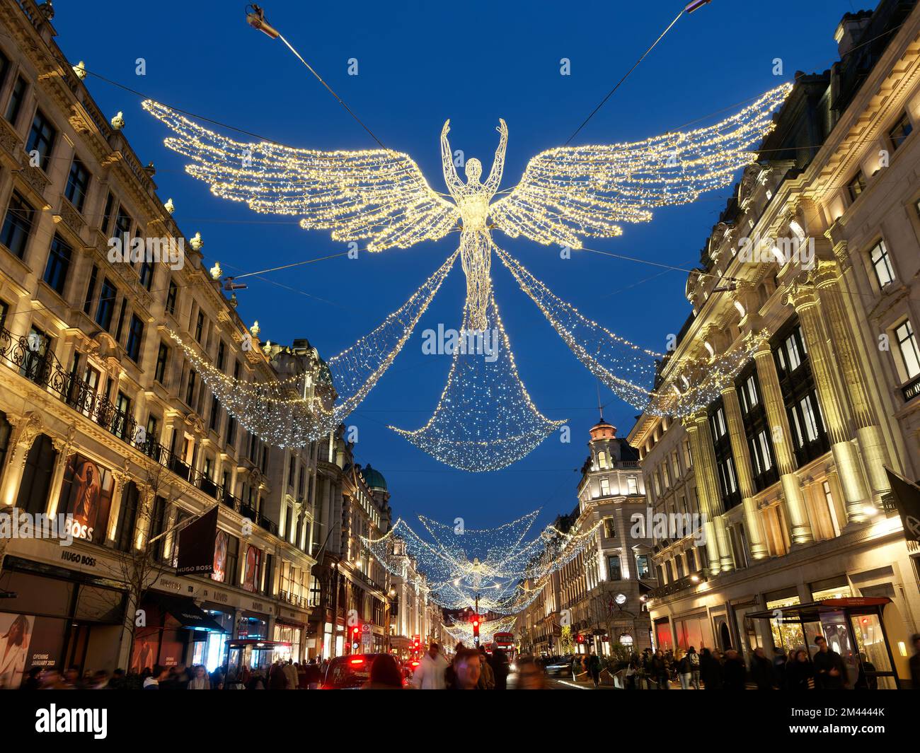 View looking up at the festive Christmas Angel decorations at night in Regent Street London 2022 Stock Photo