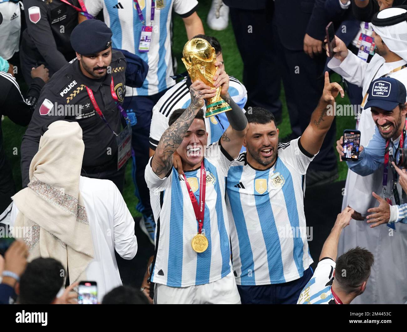 Argentina's Enzo Fernandez (left) and Sergio Aguero lifts the FIFA ...