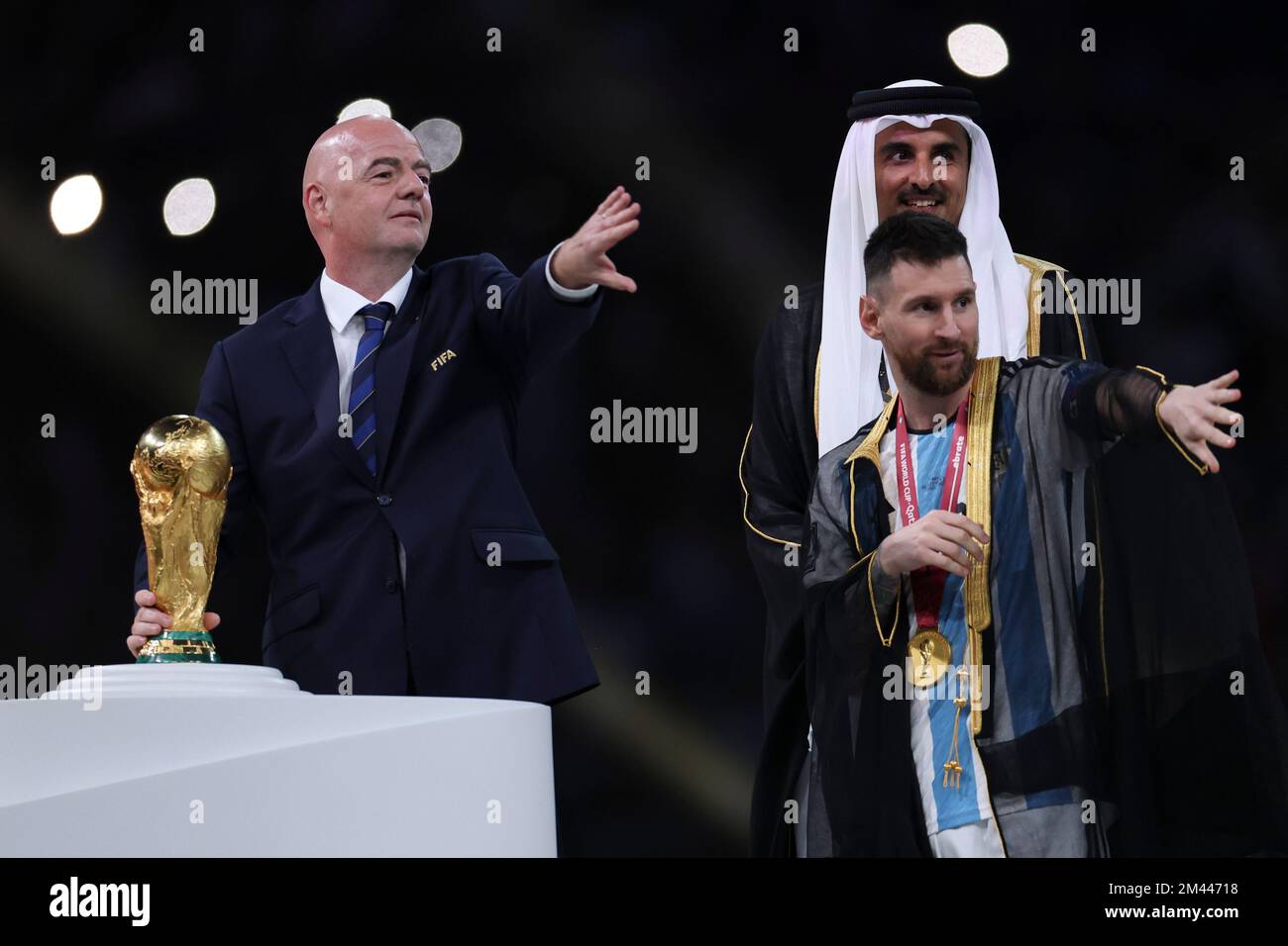 Lusaier, Qatar. 18th Dec, 2022. FIFA President Gianni Infantino (L) and The Emir of Qatar Sheikh Tamim bin Hamad Al Thani (C) and Lionel Messi of Argentina gesture during the awarding ceremony of the 2022 FIFA World Cup at Lusail Stadium in Lusail, Qatar, Dec. 18, 2022. Credit: Li Ming/Xinhua/Alamy Live News/Alamy Live News Stock Photo