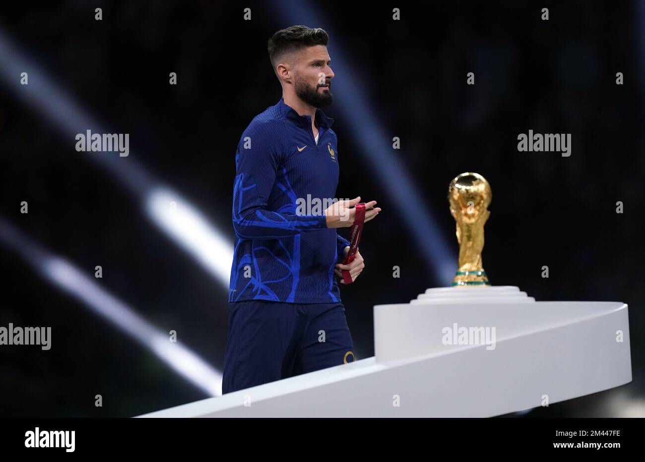 France's Olivier Giroud looks dejected as he walks past the World Cup Trophy following defeat to Argentina in the FIFA World Cup final at Lusail Stadium, Qatar. Picture date: Sunday December 18, 2022. Stock Photo