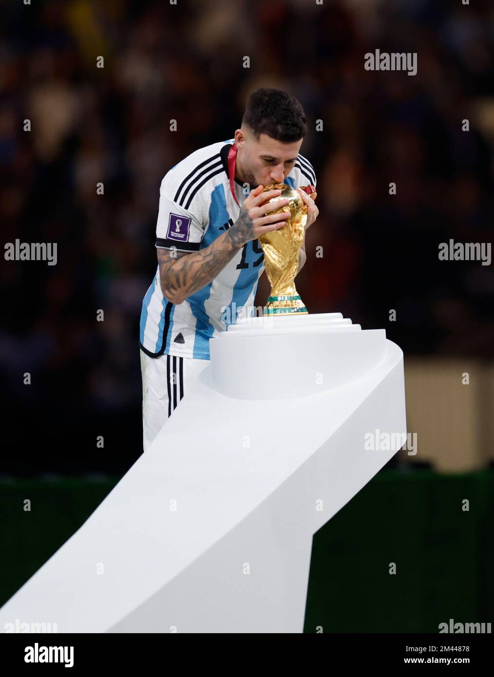 Lusail, Qatar. 18th Dec, 2022. Nicolas Otamendi of Argentina kisses the World Cup Trophy during the awarding ceremony of the 2022 FIFA World Cup at Lusail Stadium in Lusail, Qatar, Dec. 18, 2022. Credit: Wang Lili/Xinhua/Alamy Live News Stock Photo