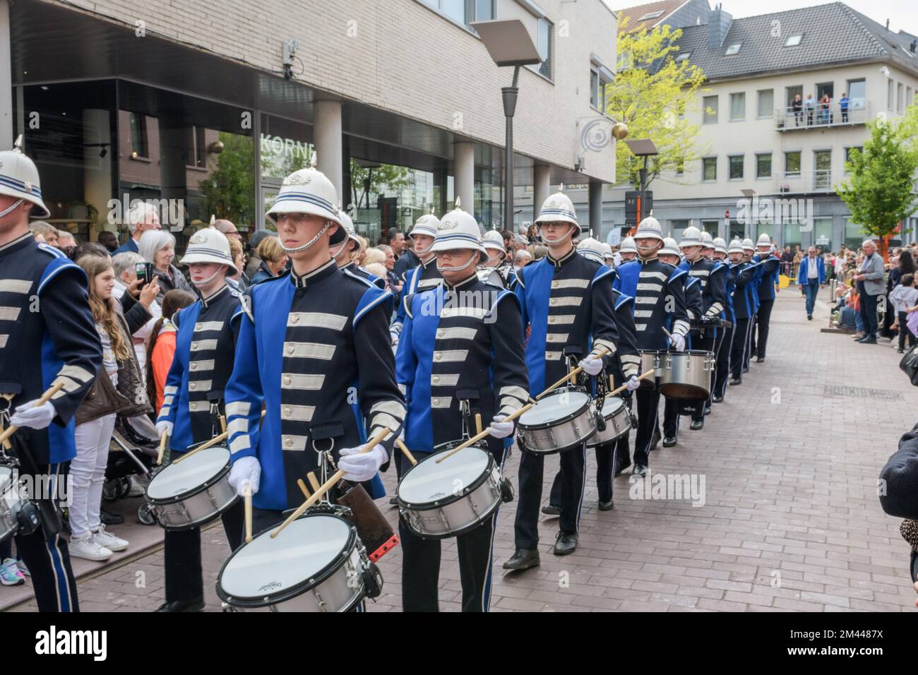 Genk. Limburg -Belgium 01-05-2022. A spectacle for the citizens. O-parade. Artists in costumes on the city street. Brass and drum band in costumes. Stock Photo