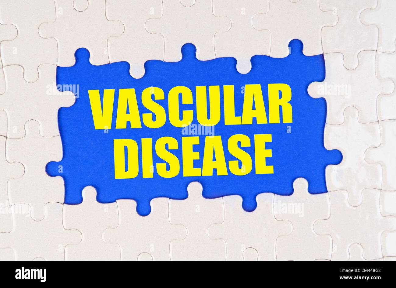 Medicine and health concept. Inside the white puzzles on a blue background it is written - vascular disease Stock Photo