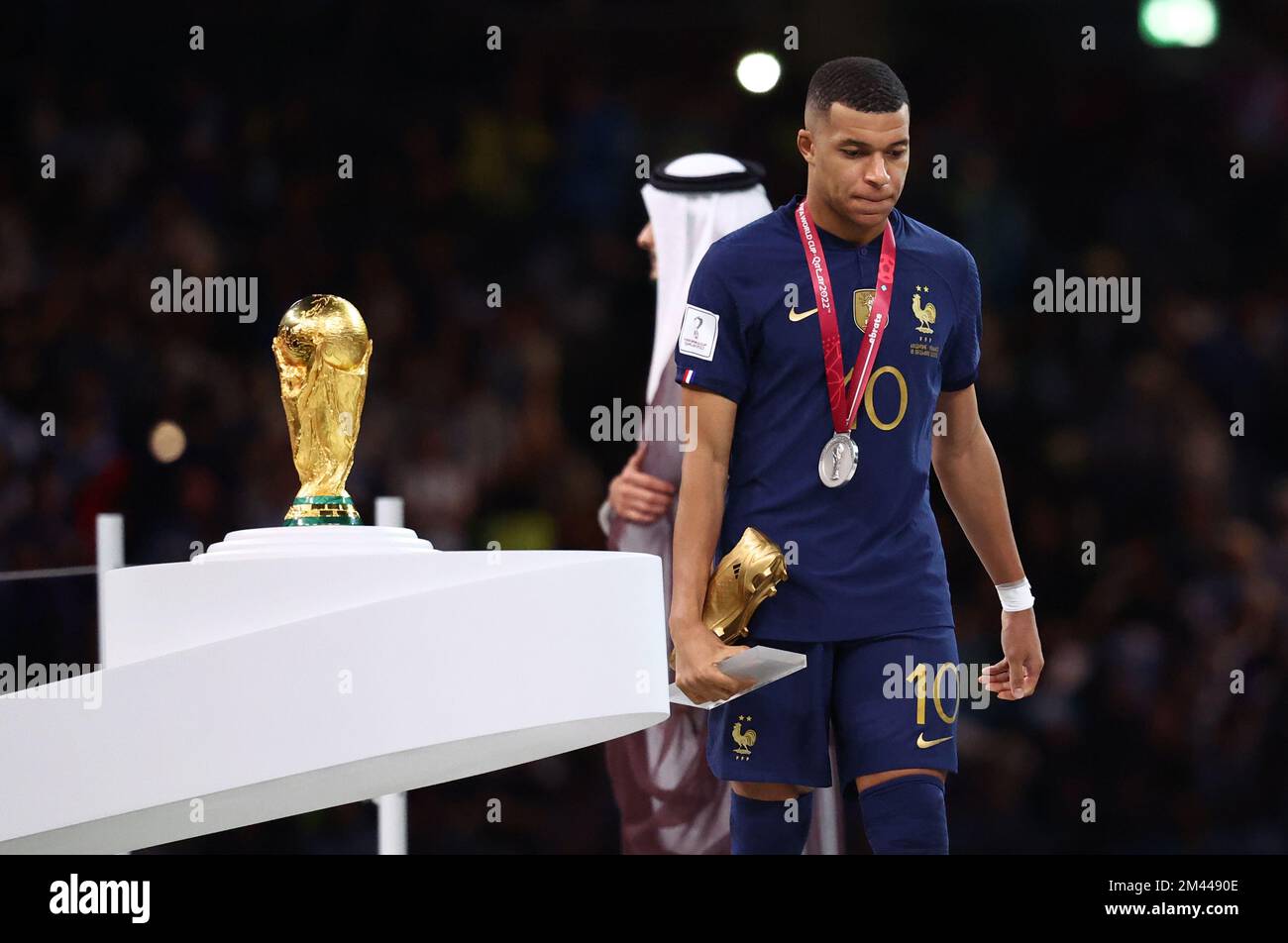 Doha, Qatar, 18th December 2022. Kylan Mbappe of France walks past the World Cup as he collects