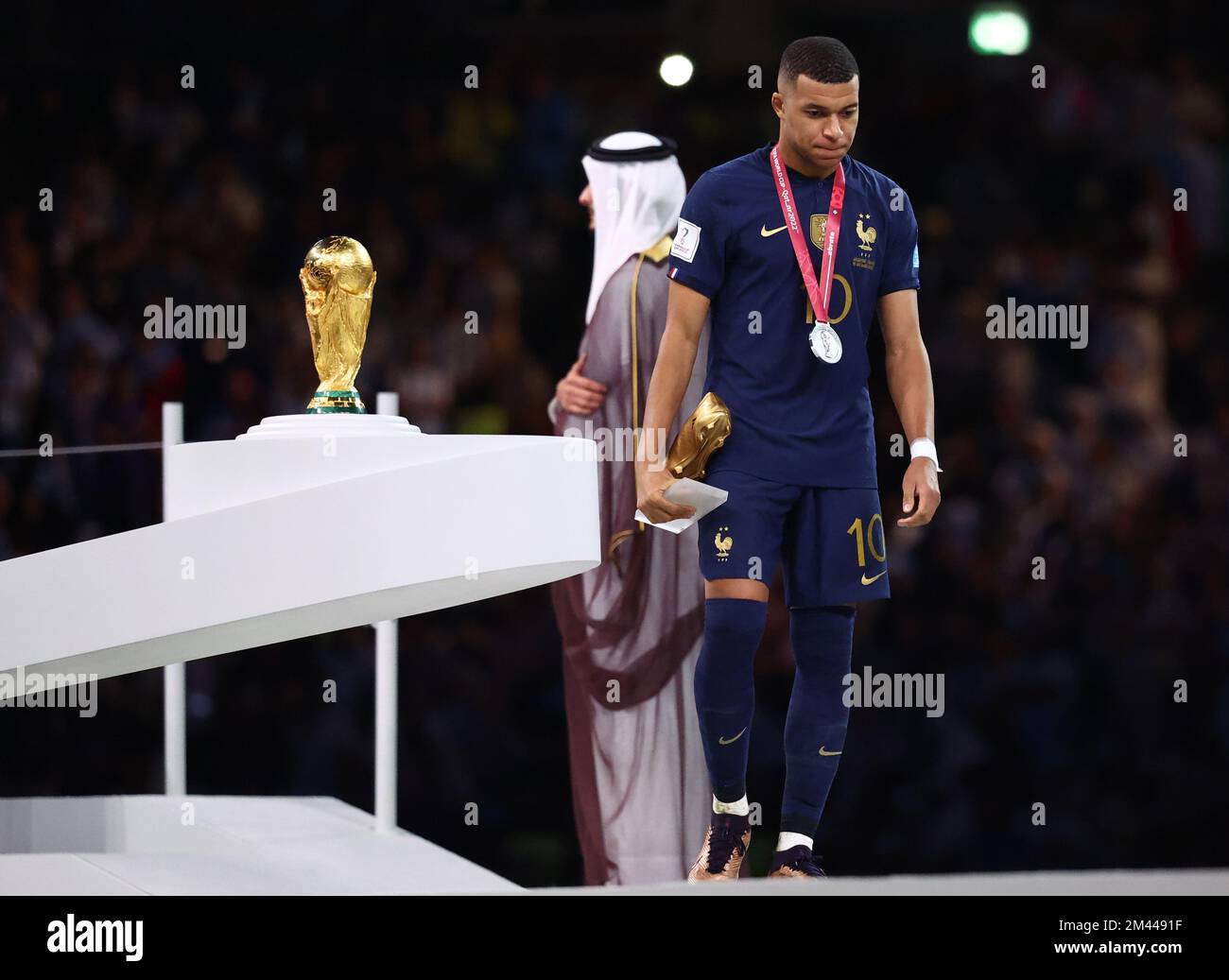 Doha, Qatar, 18th December 2022. Kylan Mbappe of France walks past the World Cup as he collects