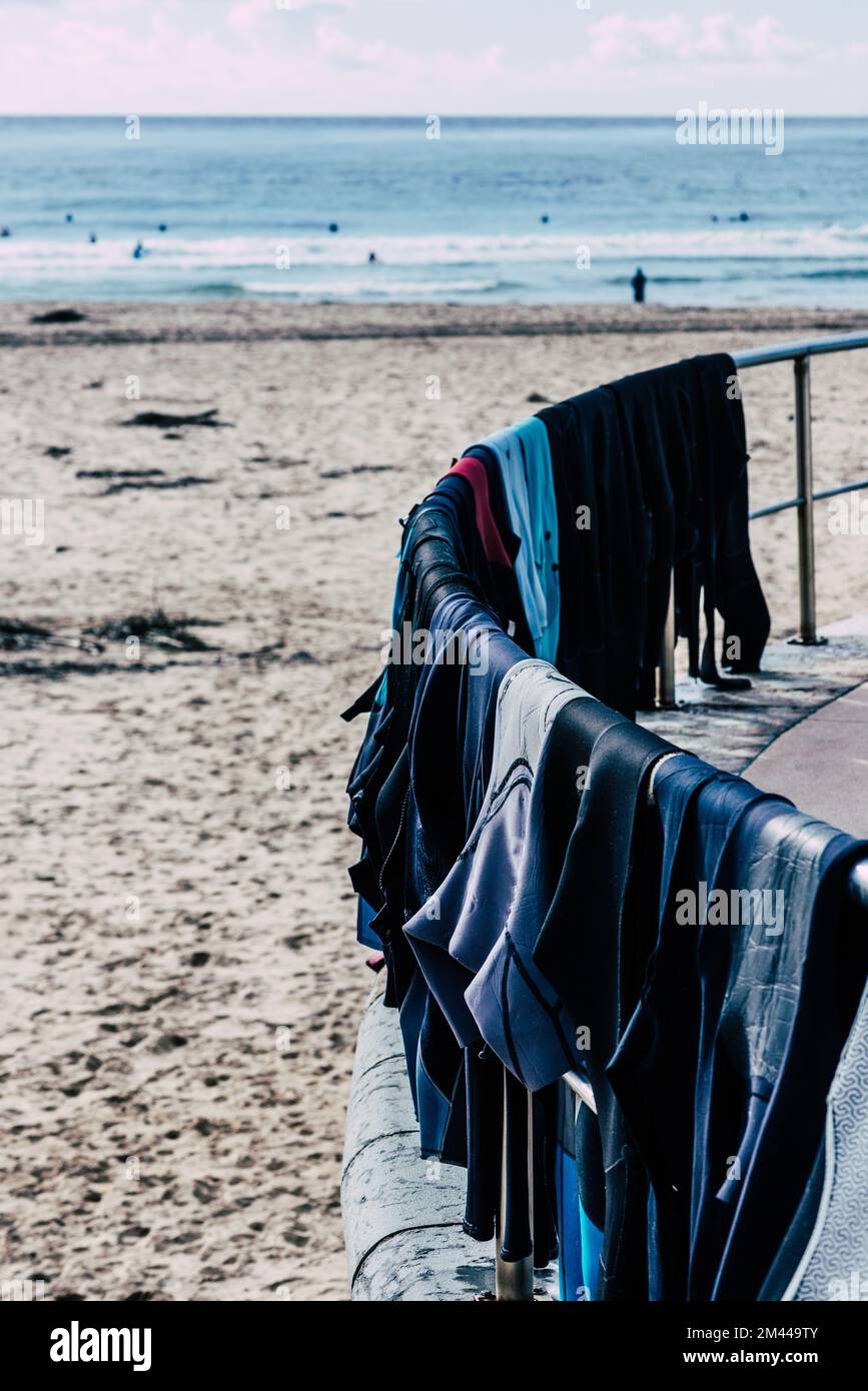 Surf wetsuits drying on the beach in Portugal Stock Photo Alamy