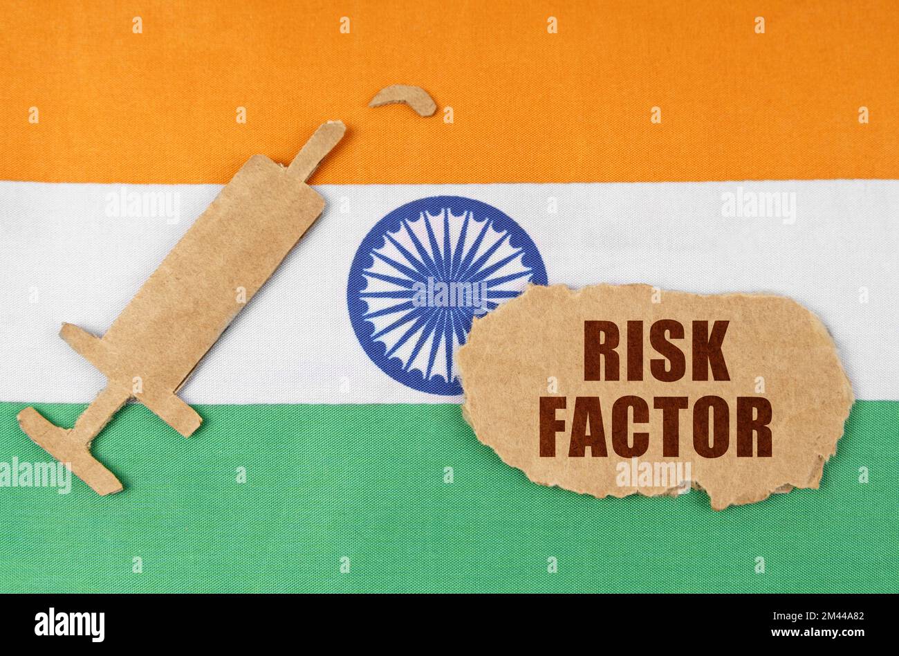 Medical concept. On the flag of India, a cardboard figure of a syringe ...