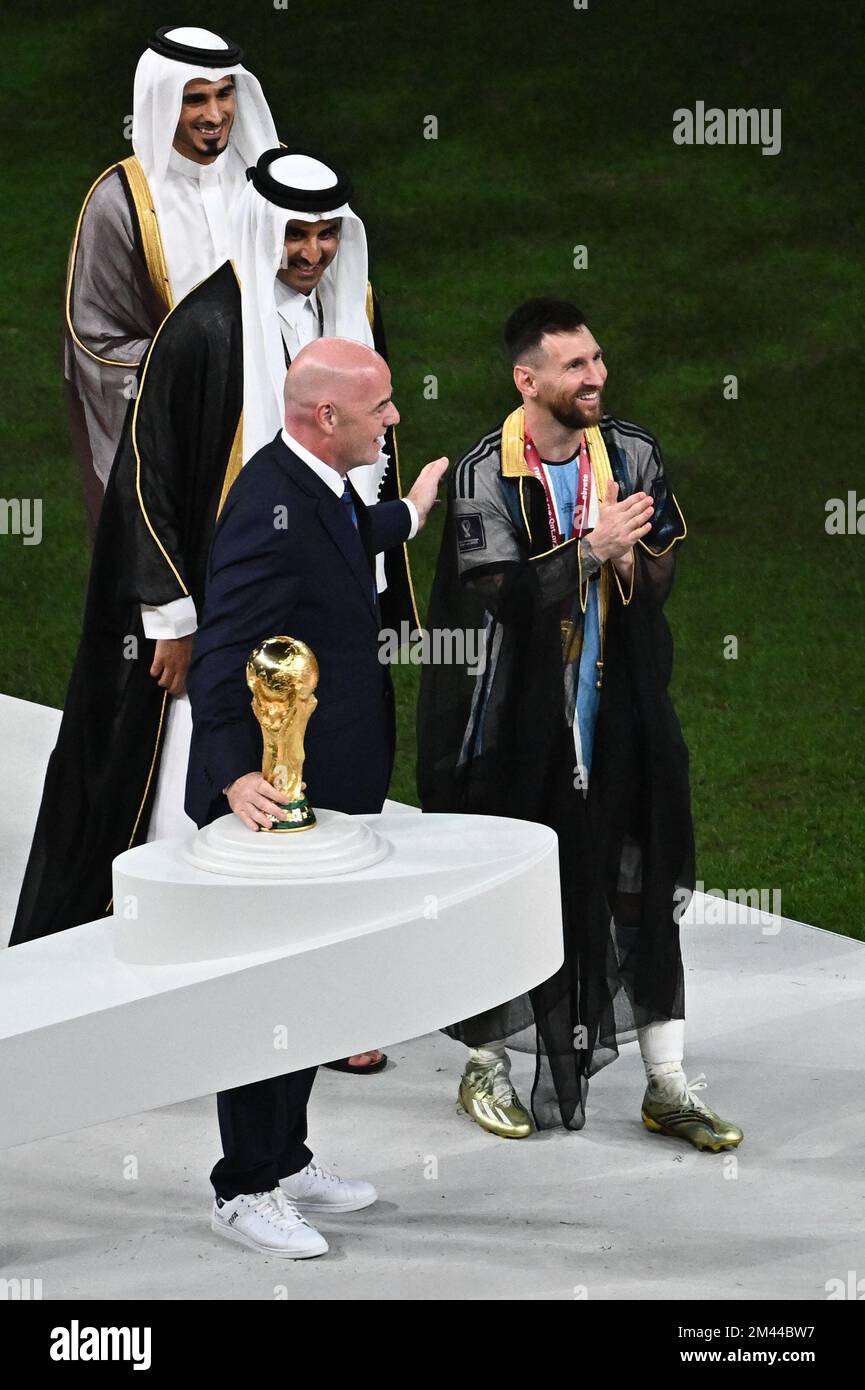 Doha, Qatar on December 18, 2022. Lionel Messi of Argentina receives a robe  from Tamim bin Hamad Al Thani the Emir of Qatar during the FIFA World Cup  Qatar 2022 Final match